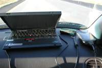 Throwing caution and automobile safety to the wind, the Wardriving equipment placed on the dash for better reception. The laptop is collecting data via NetStumbler. The eTrex GPS is providing Latitude and Longitude data for the laptop. The Compaq iPaq is cross-checking the stumbled data using Air Magnet software.

Now, you can see the need for the 8-port power strip.